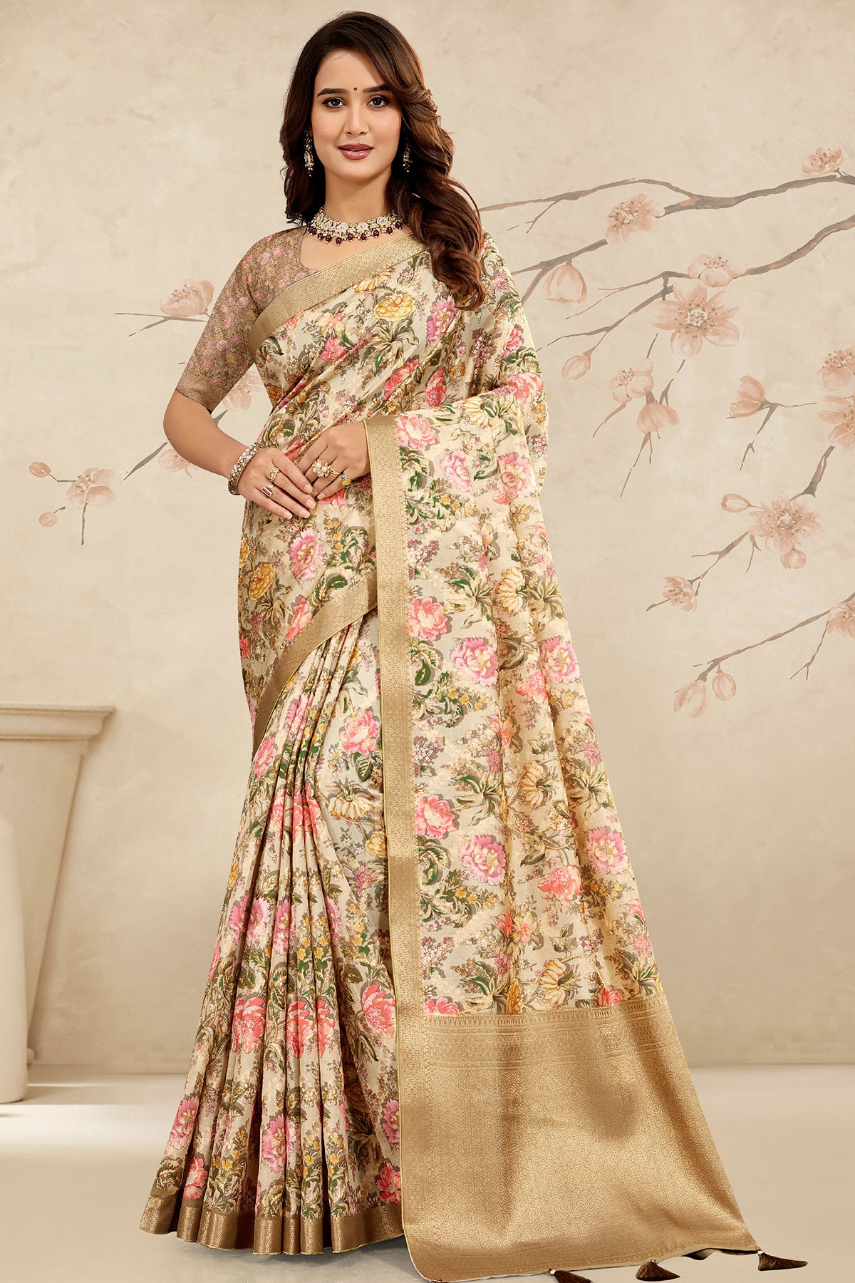 Woman wearing a floral saree with a beige background